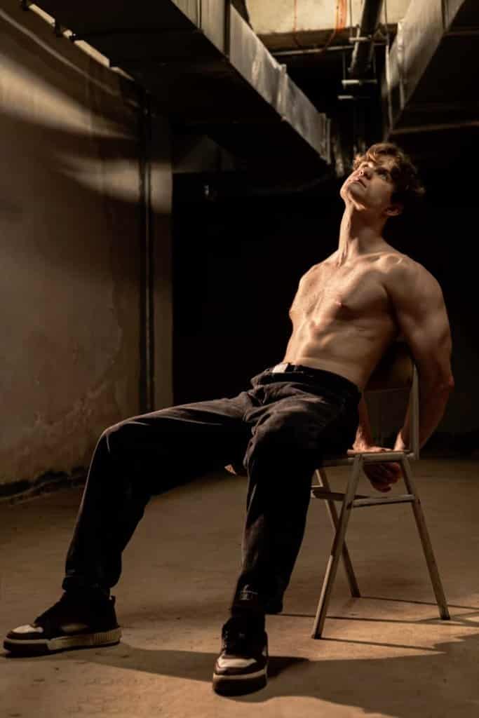 Visual Hook: Dramatic chiaroscuro lighting emphasizes the subject's upward gaze and a s...
