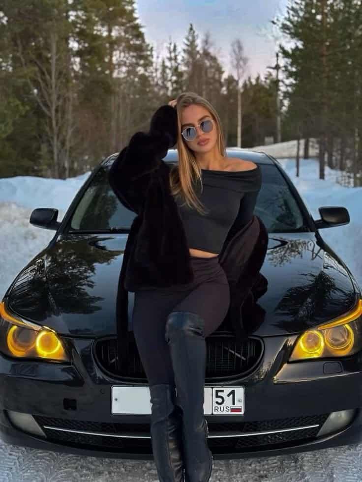 Visual Hook: A chic winter fashion statement featuring a person leaning against a luxur...